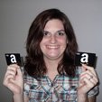 Women holding two Amazon Gift Cards she won